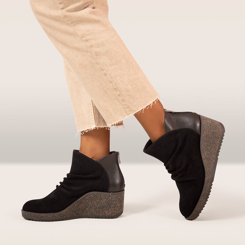 black wedge ankle boot on foot